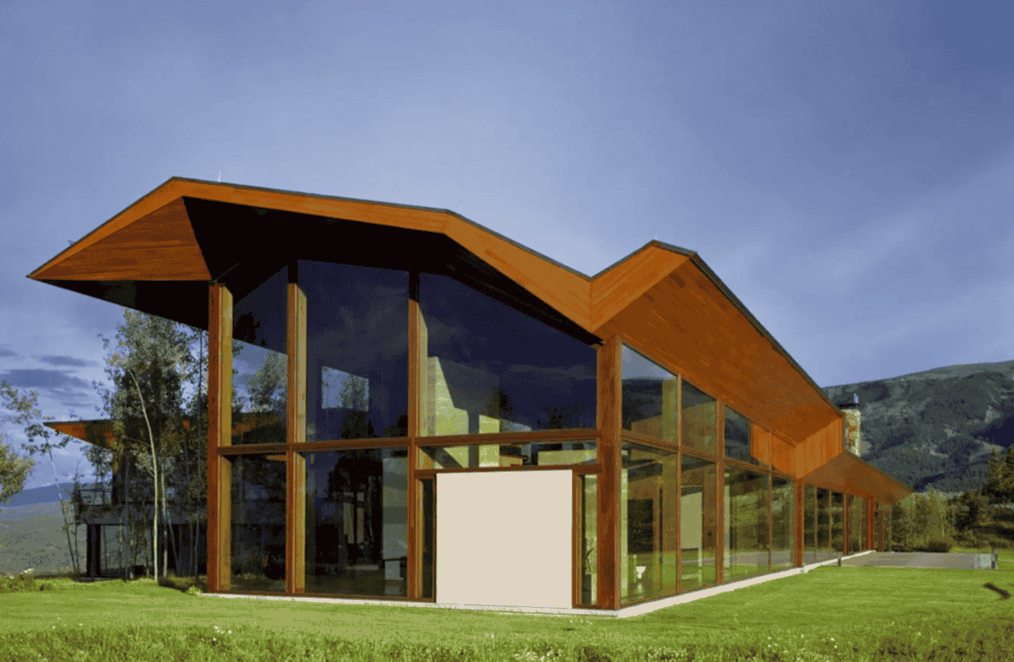 A large building with a lot of windows and a wooden roof