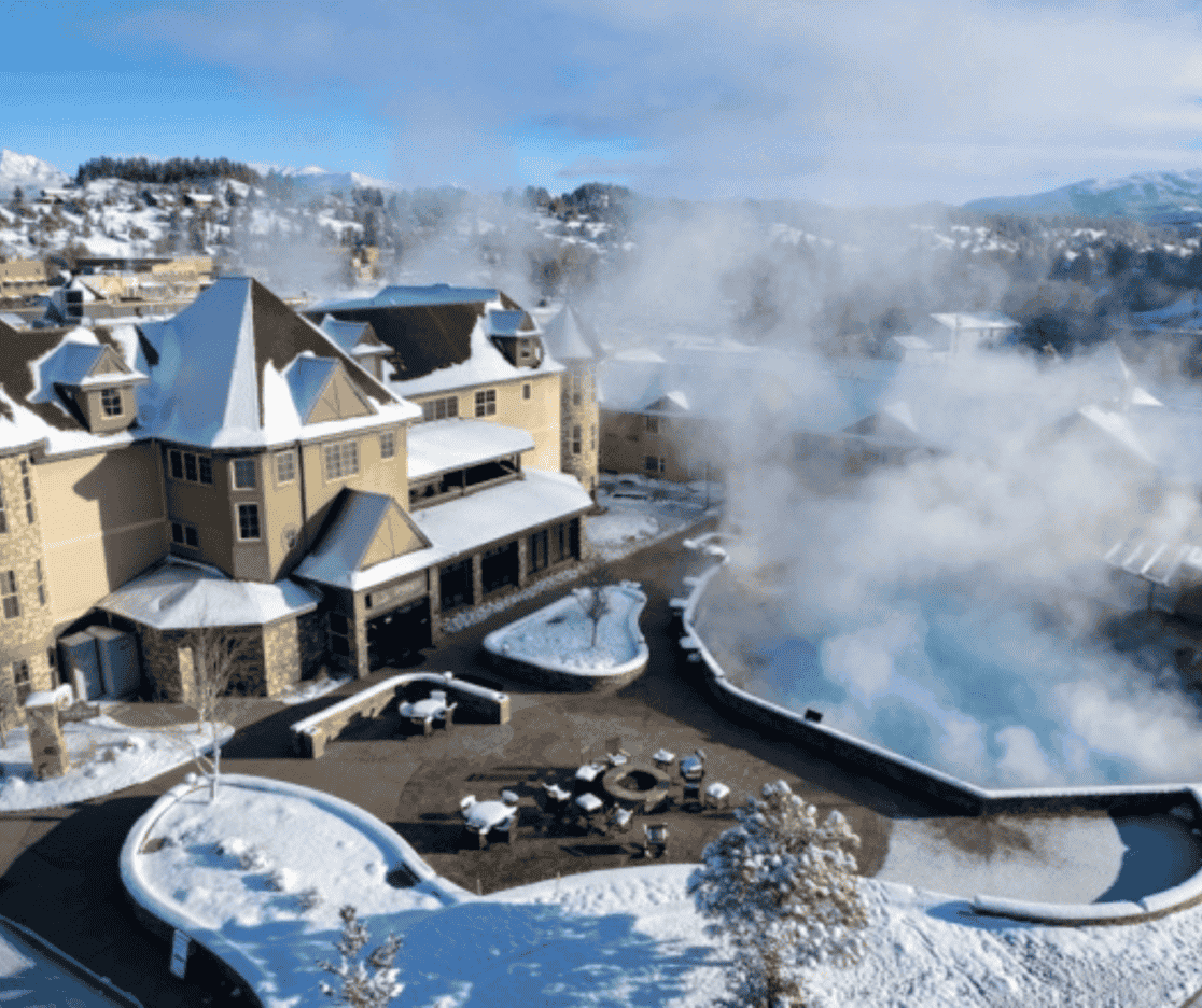 An aerial view of a hotel covered in snow and steam