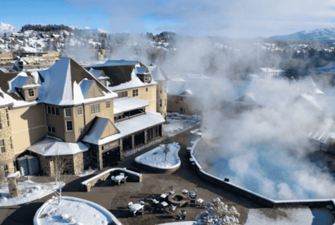 An aerial view of a hotel covered in snow and steam