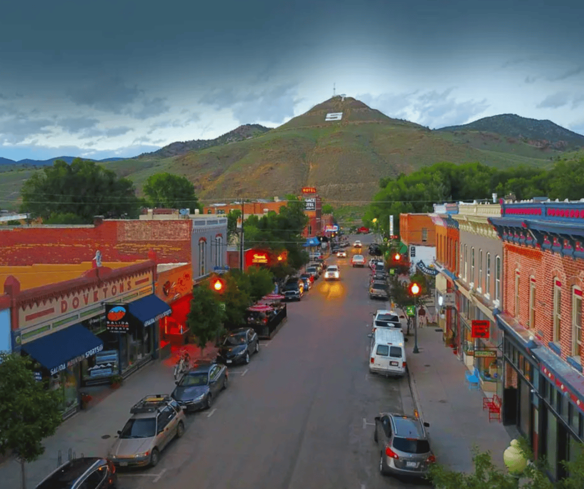 An aerial view of a small town with a mountain in the background.