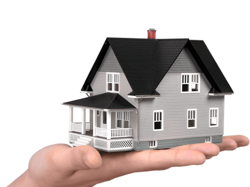 A hand is holding a model house in Aspen with a black roof 