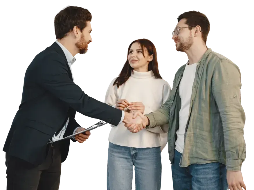 Real estate agent shakes hands with a couple, smiling. They're at a house, white background.