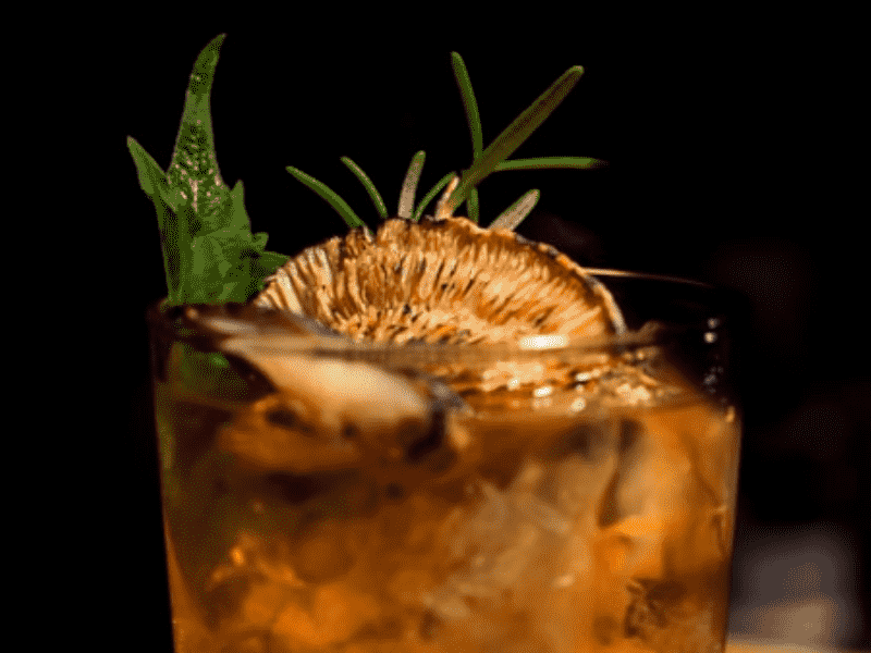 A close-up of a drink in a glass with a slice of lemon on top at an Aspen nightlife club