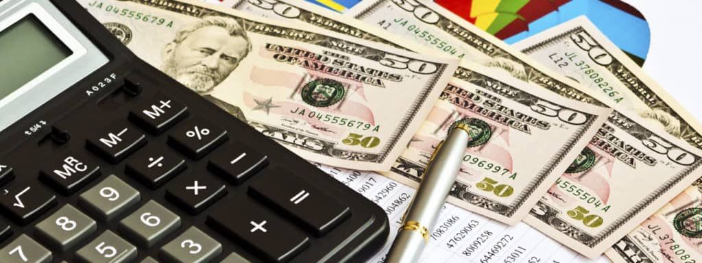 A calculator is sitting on top of a pile of money