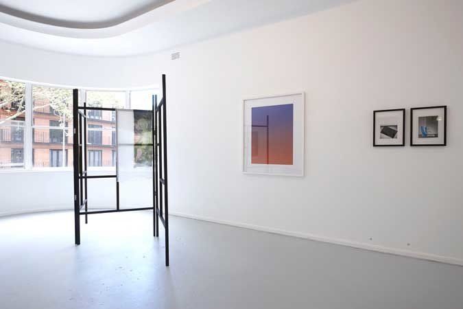 interior of a room with wall mounted paintings