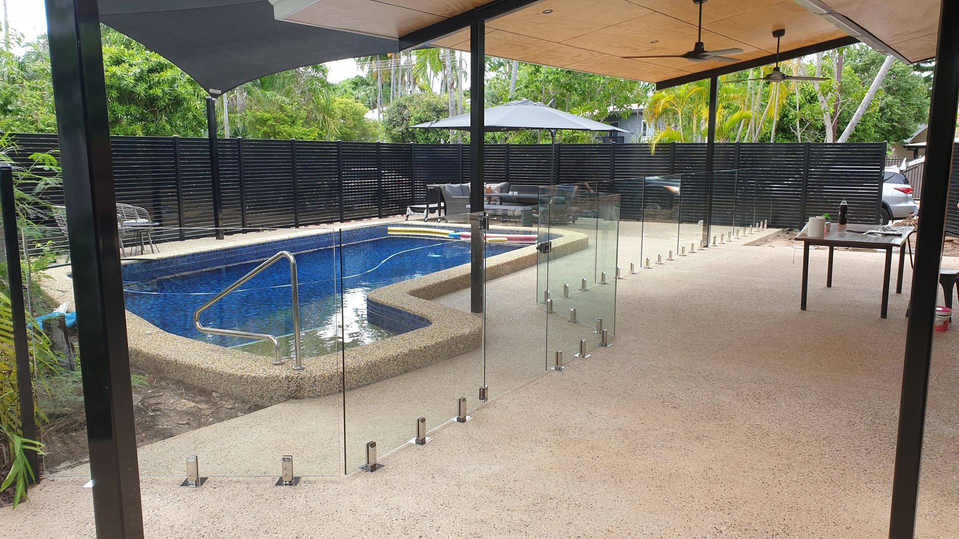 There is a swimming pool in the backyard of a house — Precision Shower Screens & Wardrobes In Yarrawonga, NT