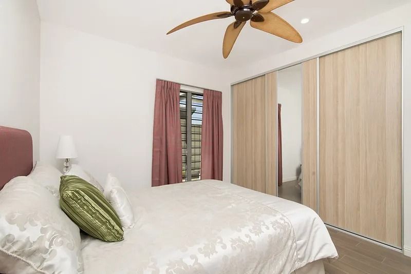 A bedroom with a bed and a ceiling fan — Precision Shower Screens & Wardrobes In Yarrawonga, NT