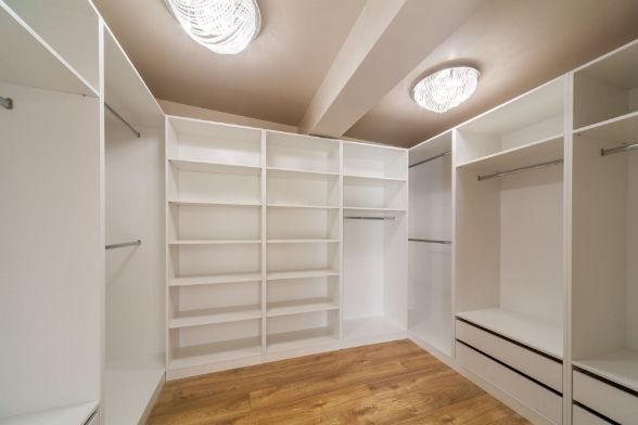 An Empty Walk in Closet With Lots of Shelves and Drawers — Precision Shower Screens & Wardrobes In Yarrawonga, NT