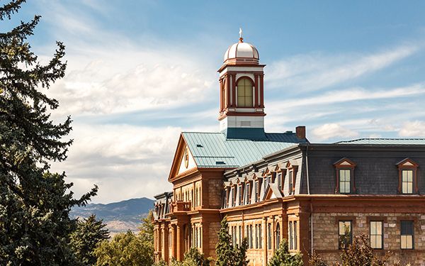 A large brick building with a clock tower on top of it.