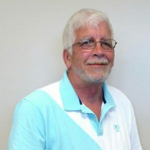 A man wearing glasses and a blue and white polo shirt