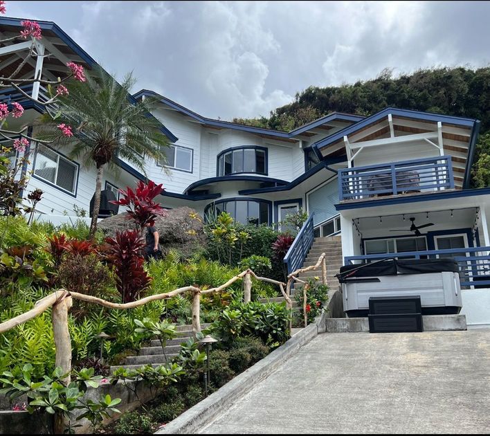 A large house with stairs leading up to it