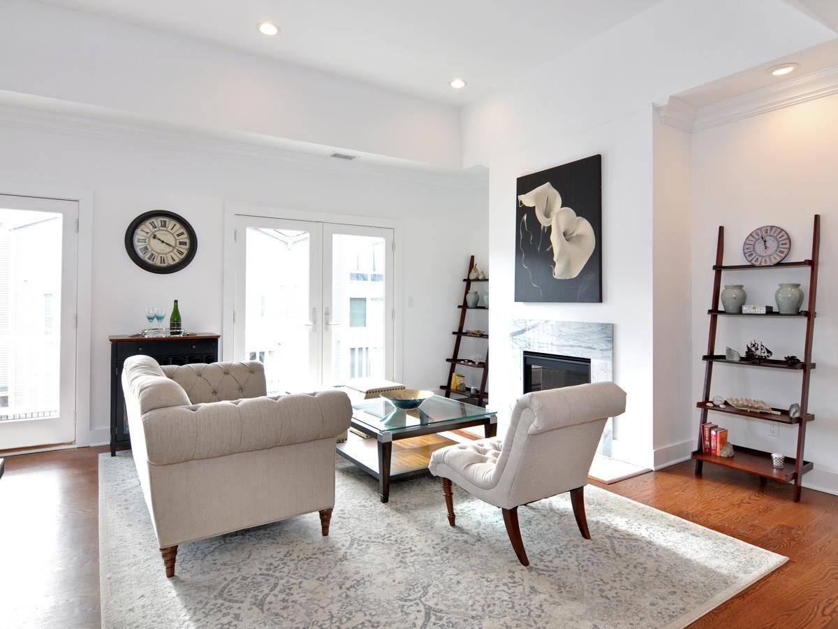 A living room with a fireplace and a clock on the wall