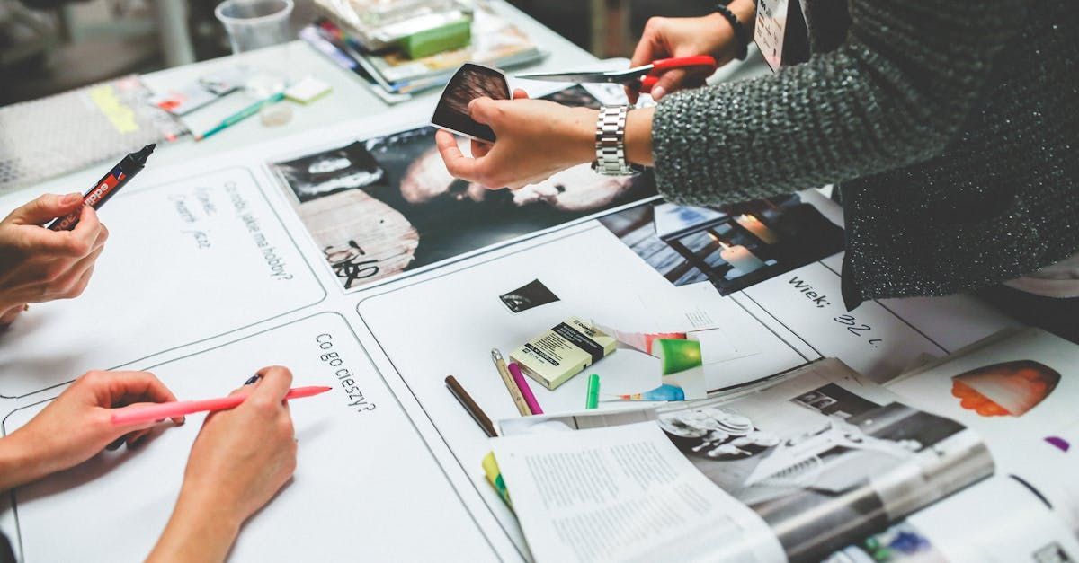 A group of people are sitting around a table working on a project.