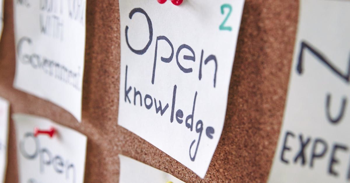 A cork board with sticky notes on it that say open knowledge