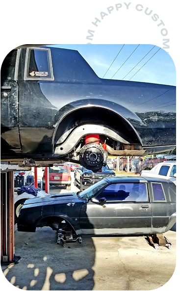 black car on lift | Gulf Coast Auto Repair