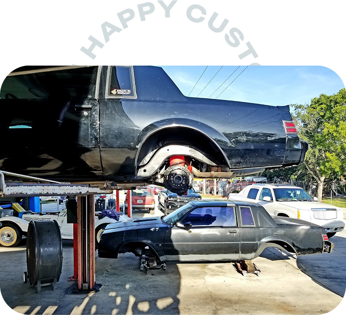 Car on lift | Gulf Coast Auto Repair