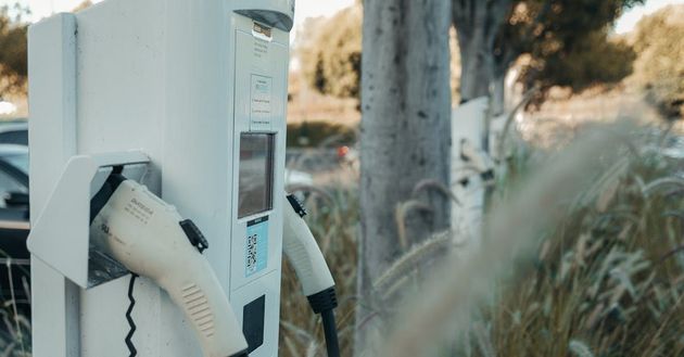 An electric car is being charged at a charging station.