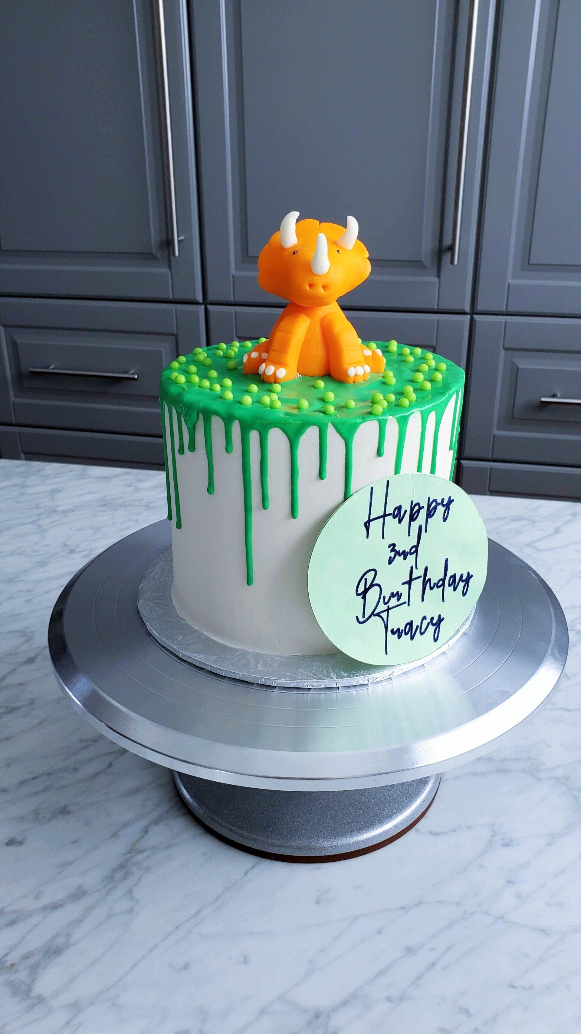 green cake with dinosaur