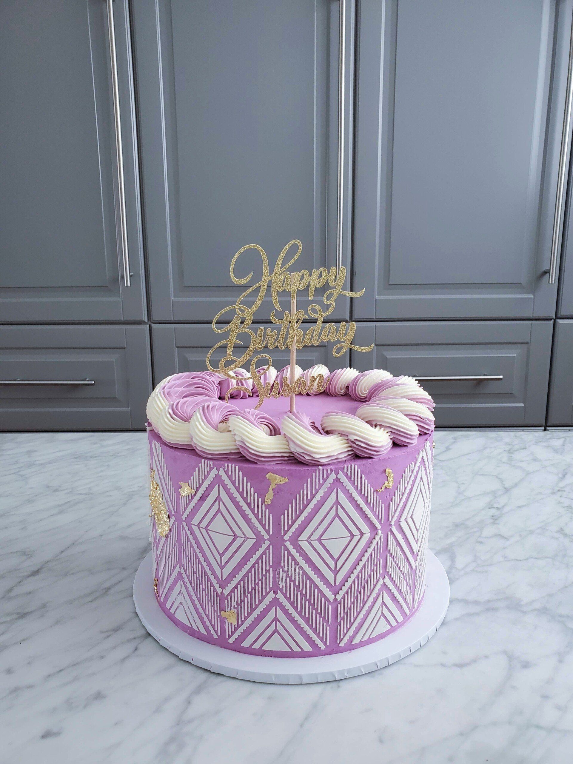 purple cake with stencil pattern and topper