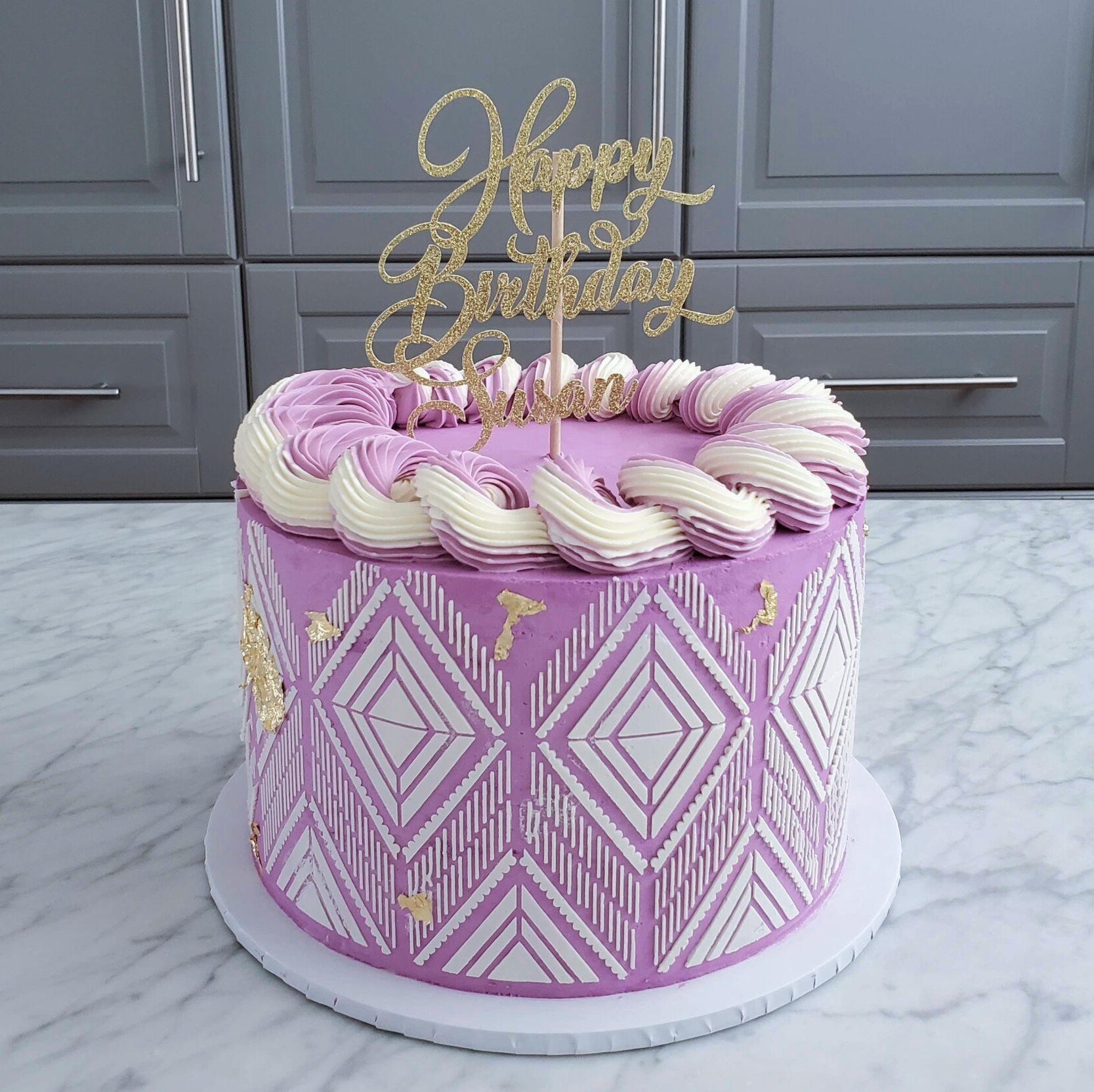 purple and white cake with stencil pattern