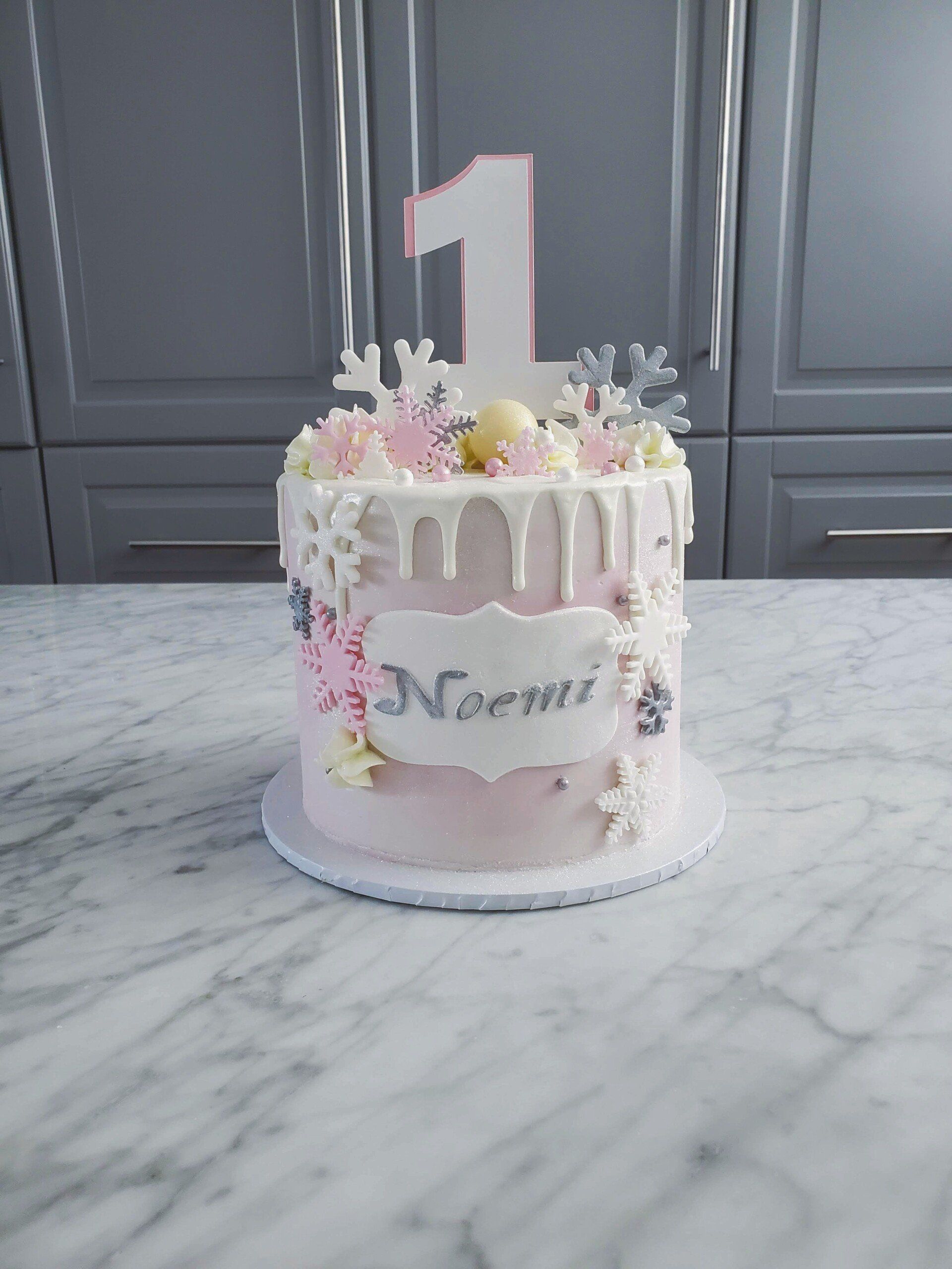 pink cake with white drip and decorations