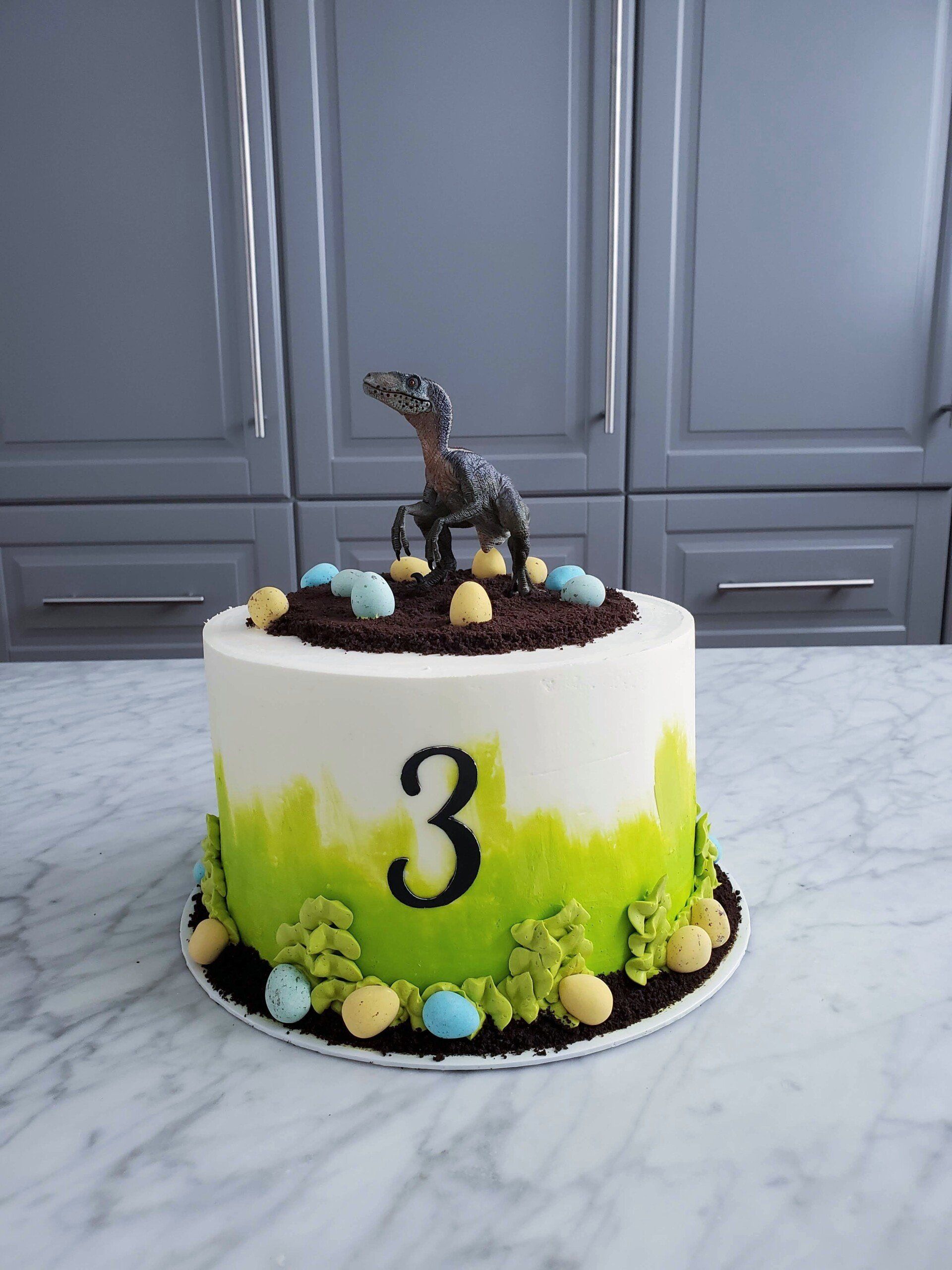 white and green dinosaur cake