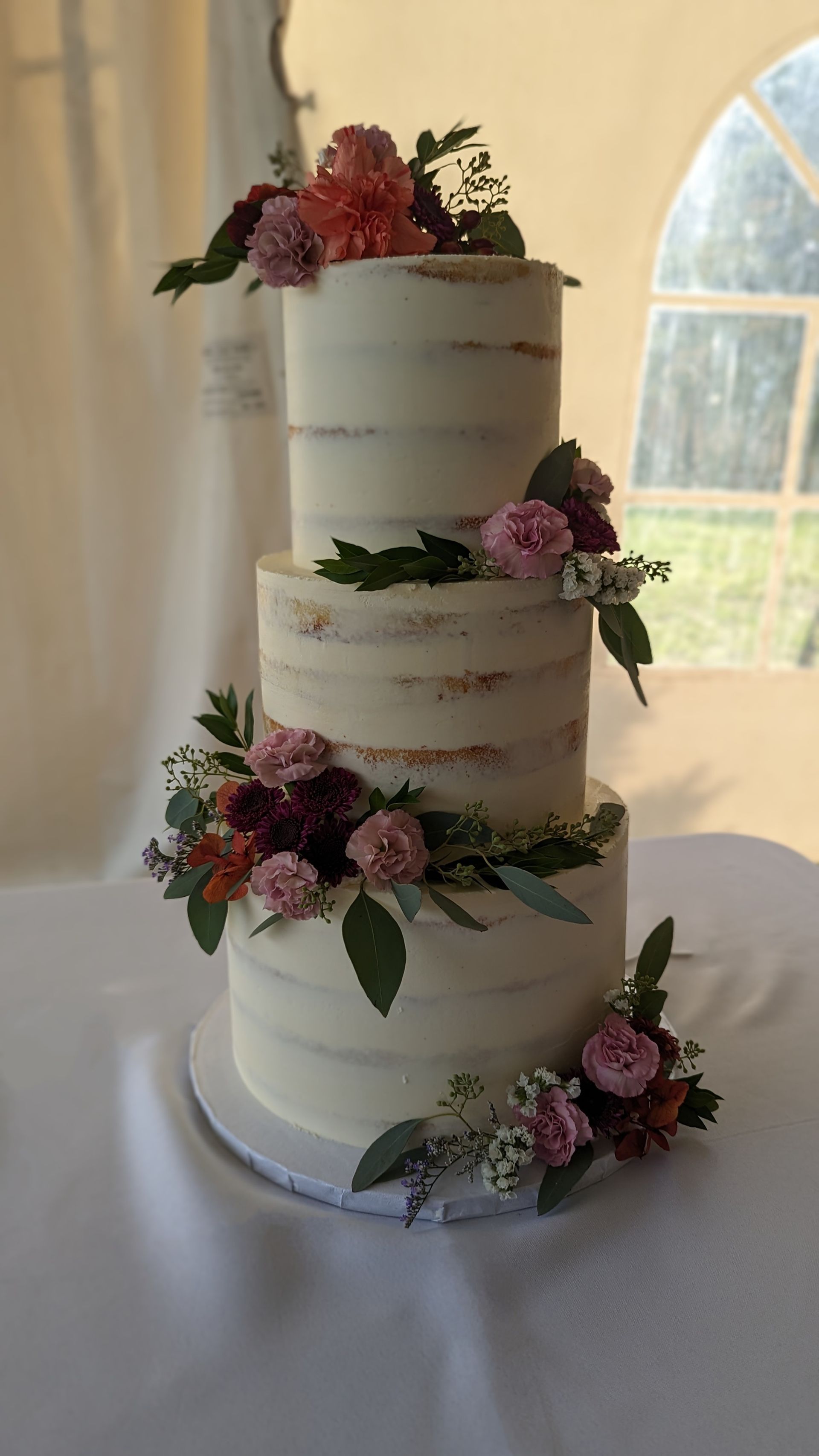 three tier semi-nude cake with florals