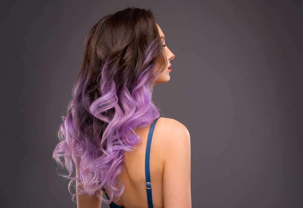 A Woman With Long Purple Hair Is Wearing A Blue Bra —  L'Auranda Hair Salon In  Evan St. Mackay, QLD