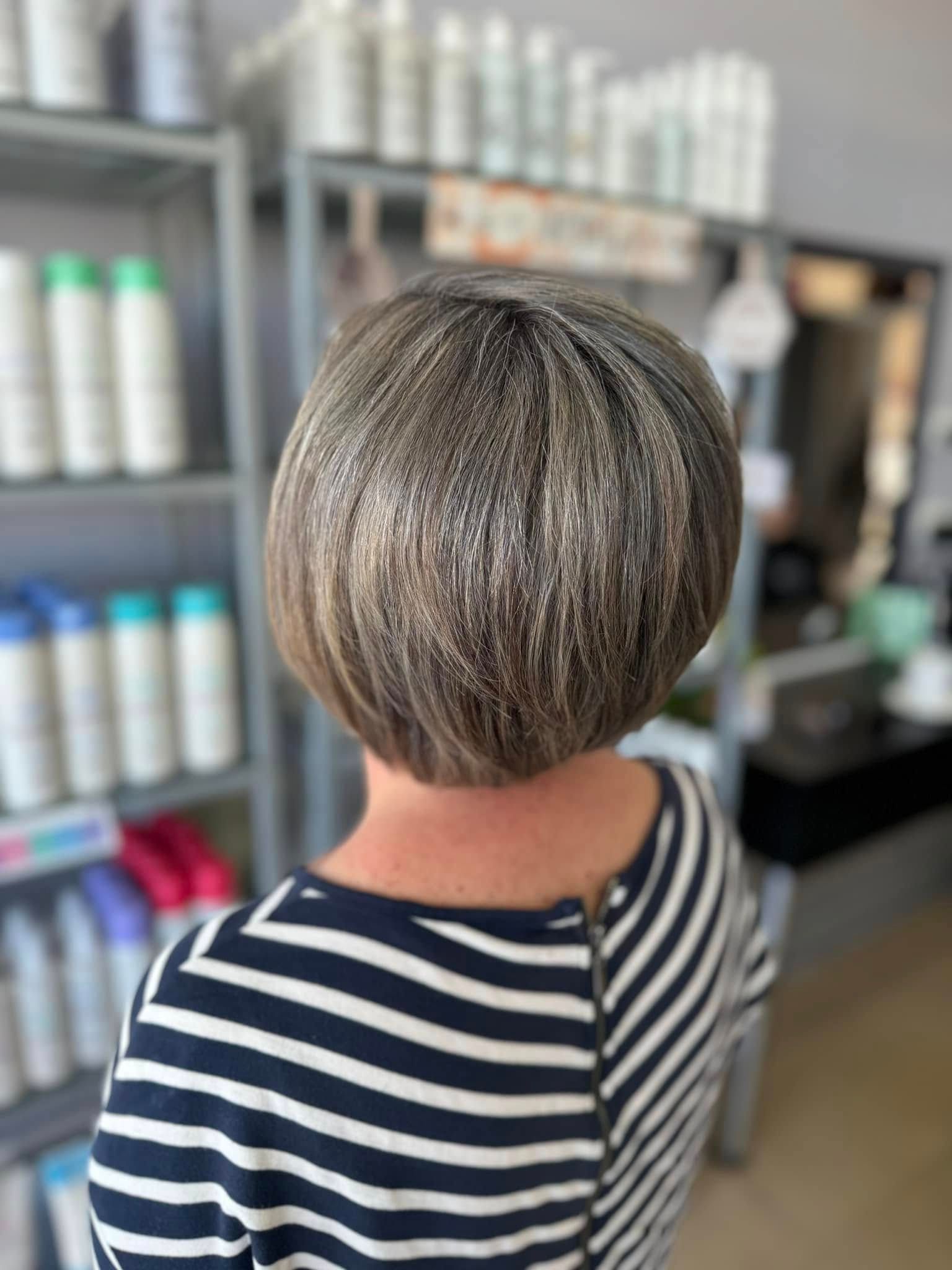 A Woman Is Getting Her Hair Done By A Hairdresser — L'Auranda Hair Salon In Evan St. Mackay, QLD