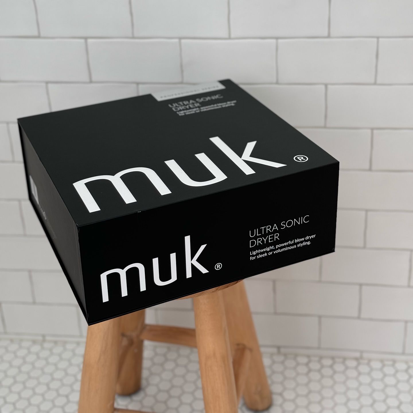 A Black Box That Says Muk Is Sitting On A Wooden Stool —  L'Auranda Hair Salon In  Evan St. Mackay, QLD