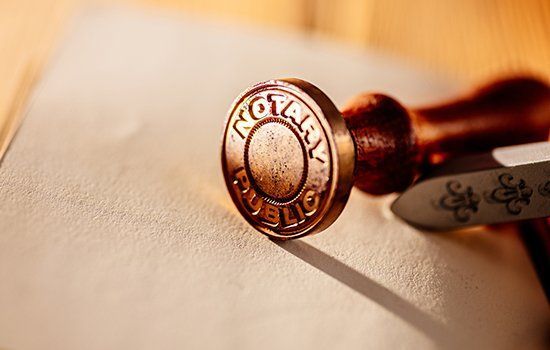 Bronze notary public stamp on paper.