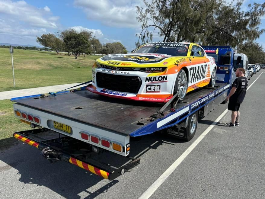 Yellow Toyota Pickup Truck On A Flatbed Tow Truck, Under A Blue Sky