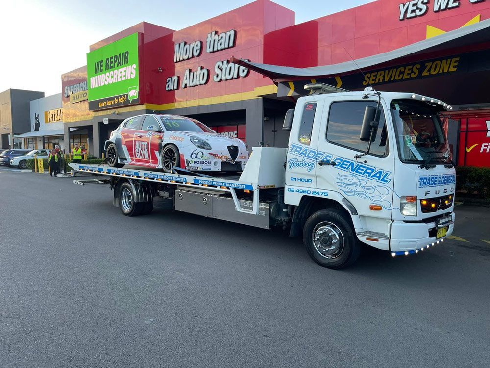 Alfa Romeo Giulietta Tow in Front of the Auto Store — Trade & General Towing in Beresfield, NSW