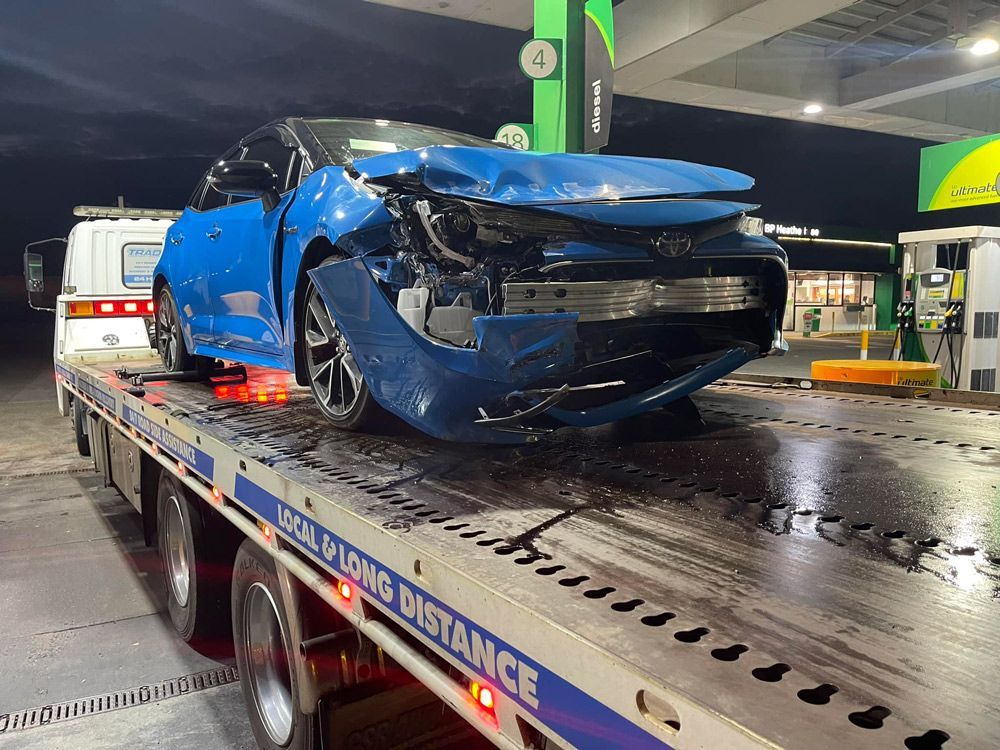 Towing the Blue Car in the Accident Area — Trade & General Towing in Sandgate, NSW