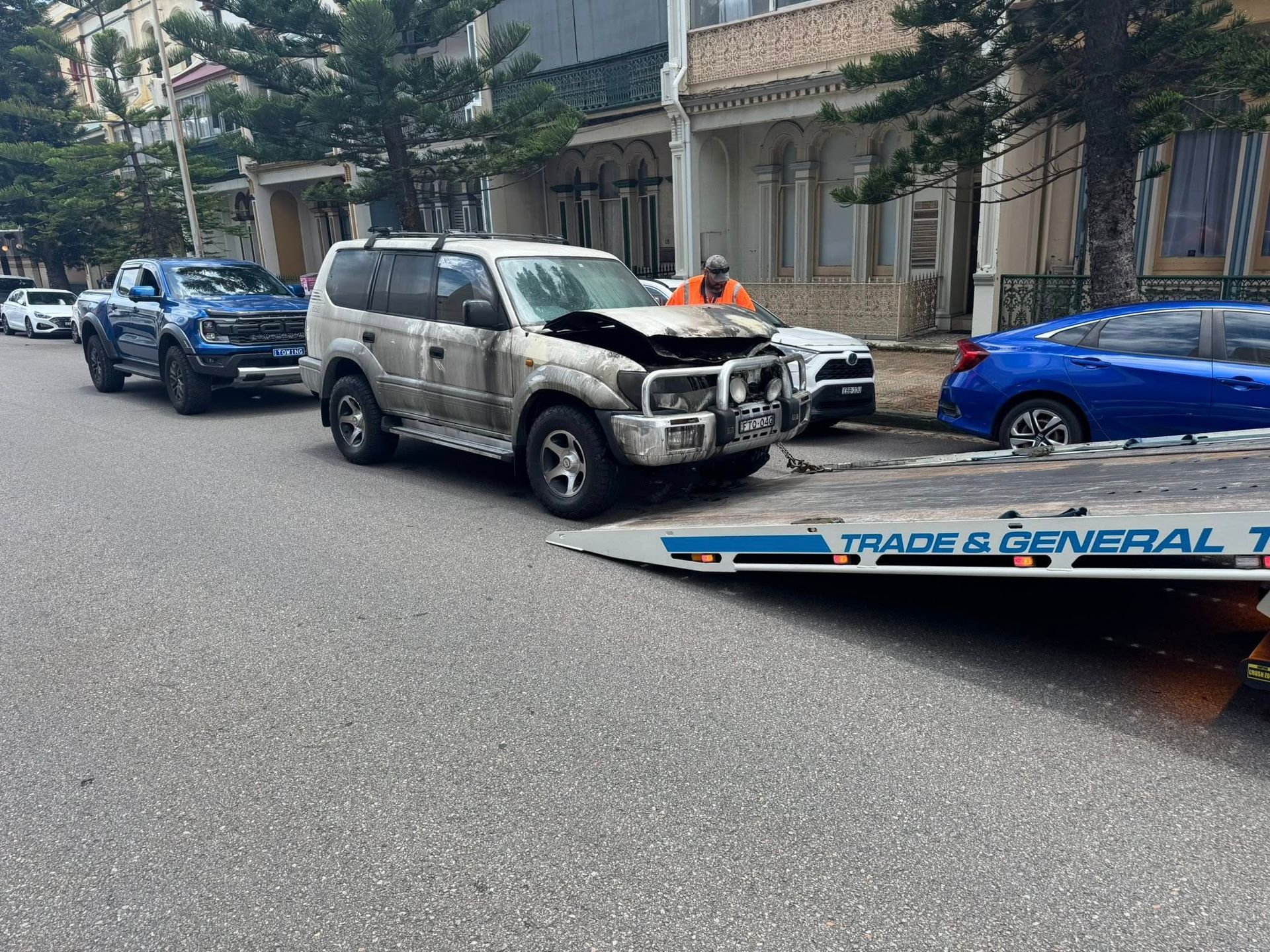 Damaged Silver SUV Loaded Onto Tow Truck Roadside
