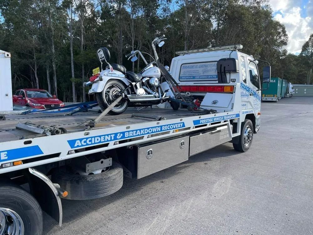 Flatbed Tow Truck Carrying a Chrome Motorcycle