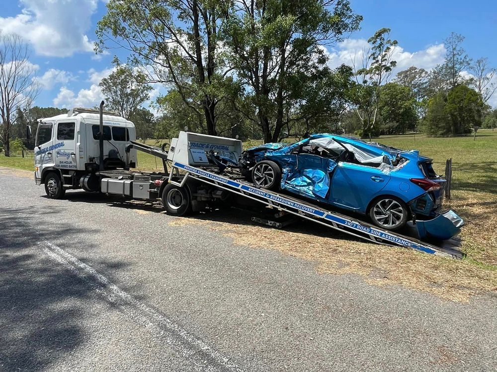 Towing the Blue Car in the Accident Area — Trade & General Towing in Sandgate, NSW