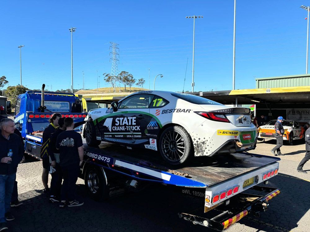 Group of People Around a Tow Truck — Trade & General Towing in Sandgate, NSW