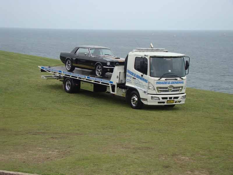 Towing The Black Car On The Sea Side — Trade & General Towing In Sandgate NSW