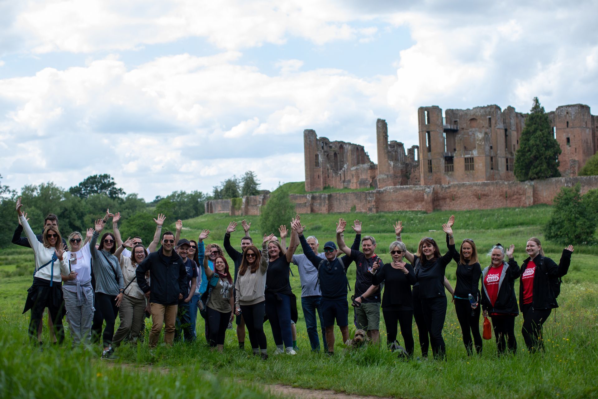 A group of people are putting their hands together in a circle.
