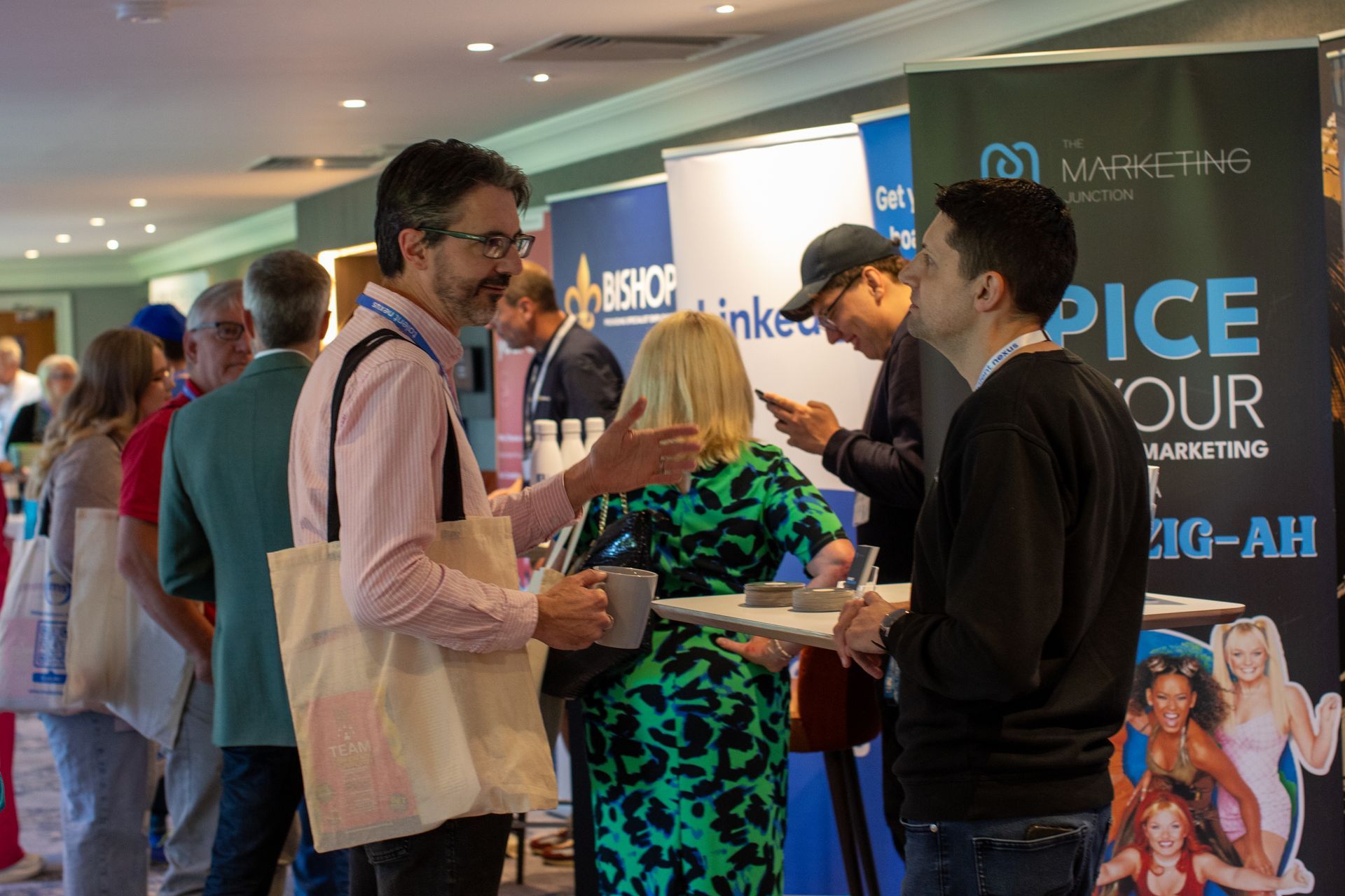 A group of people are standing around a table at a conference.