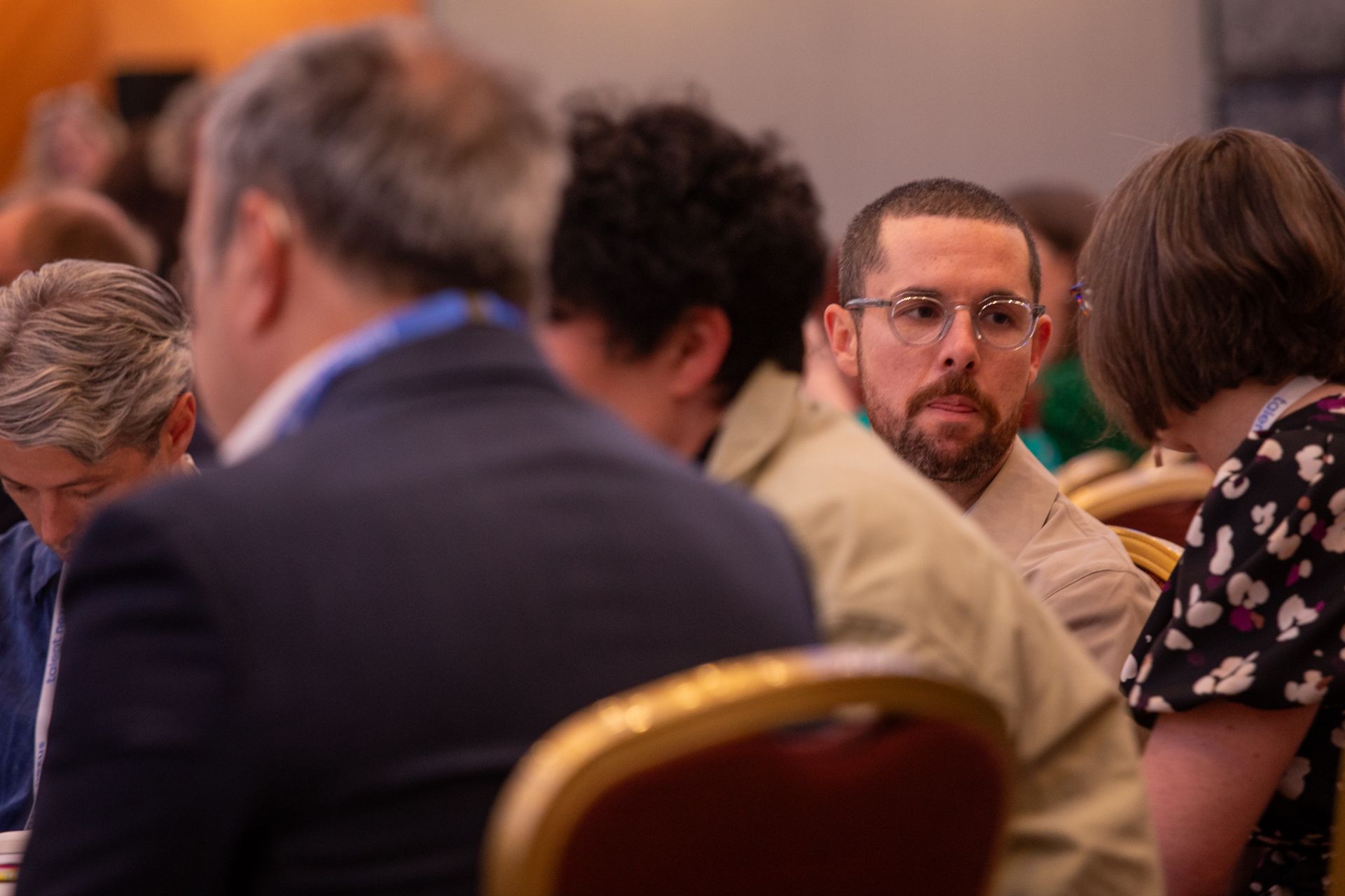 A group of people are sitting at a table in a room.