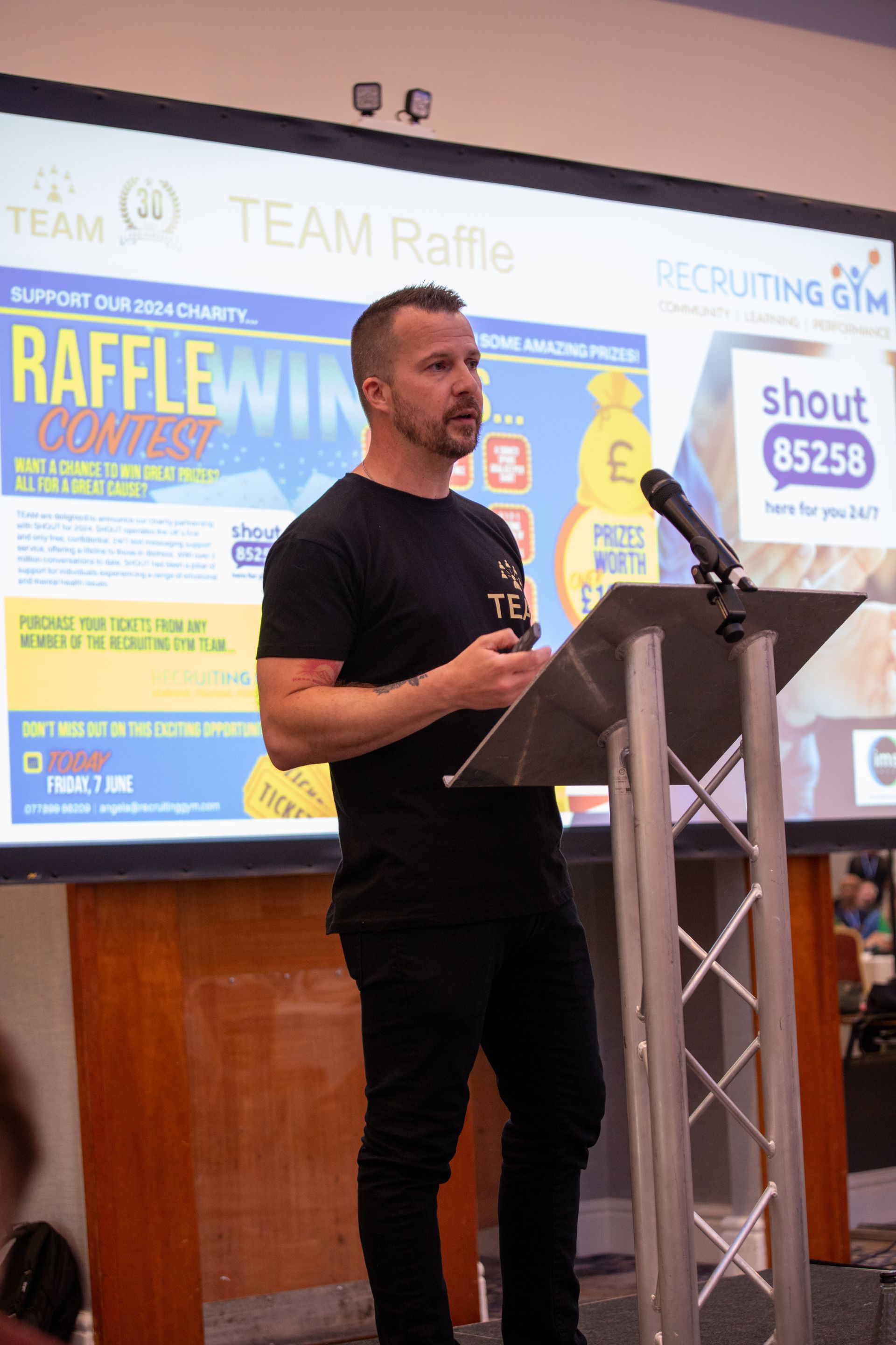 A man is standing at a podium giving a speech.
