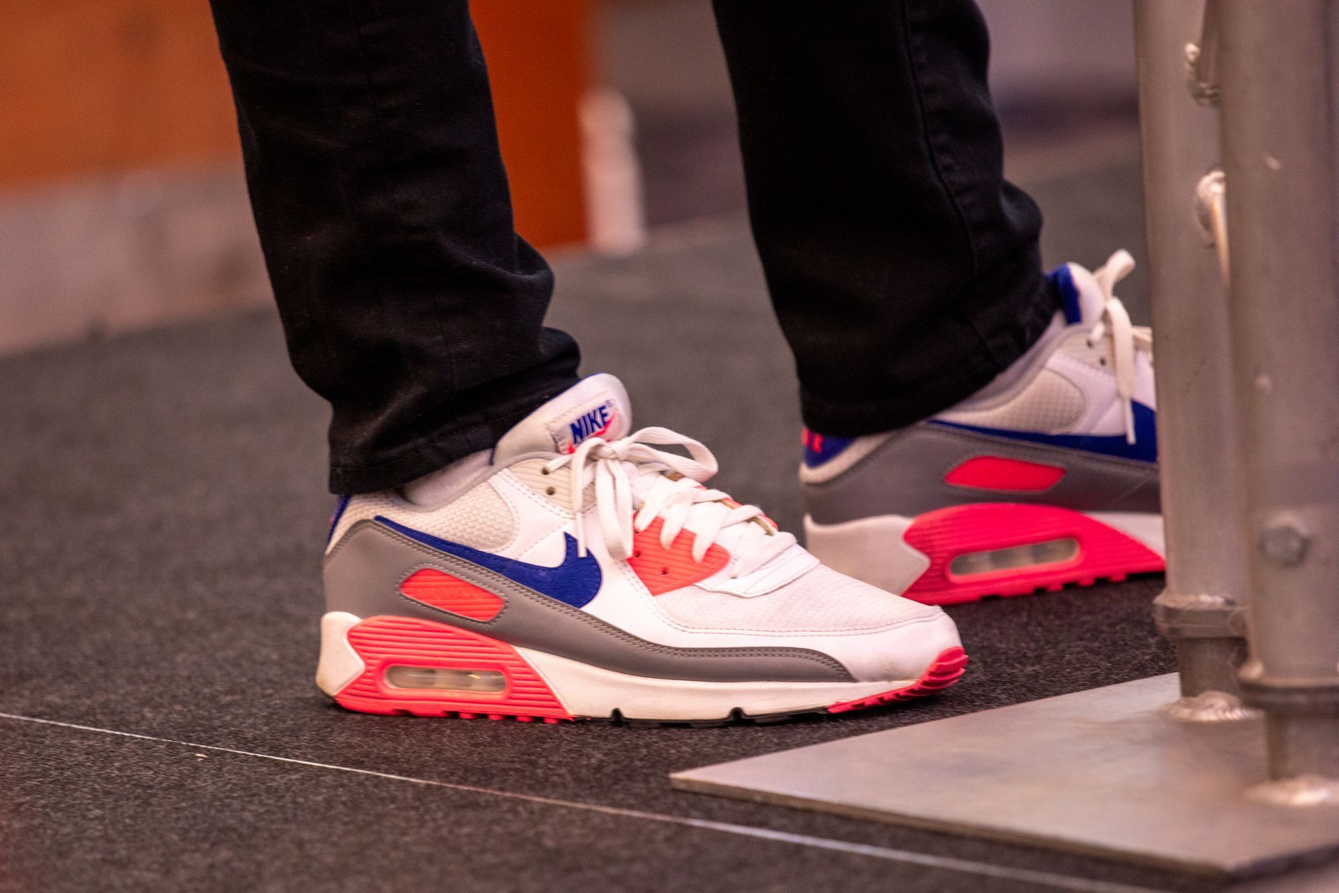 A person wearing a pair of nike air max sneakers