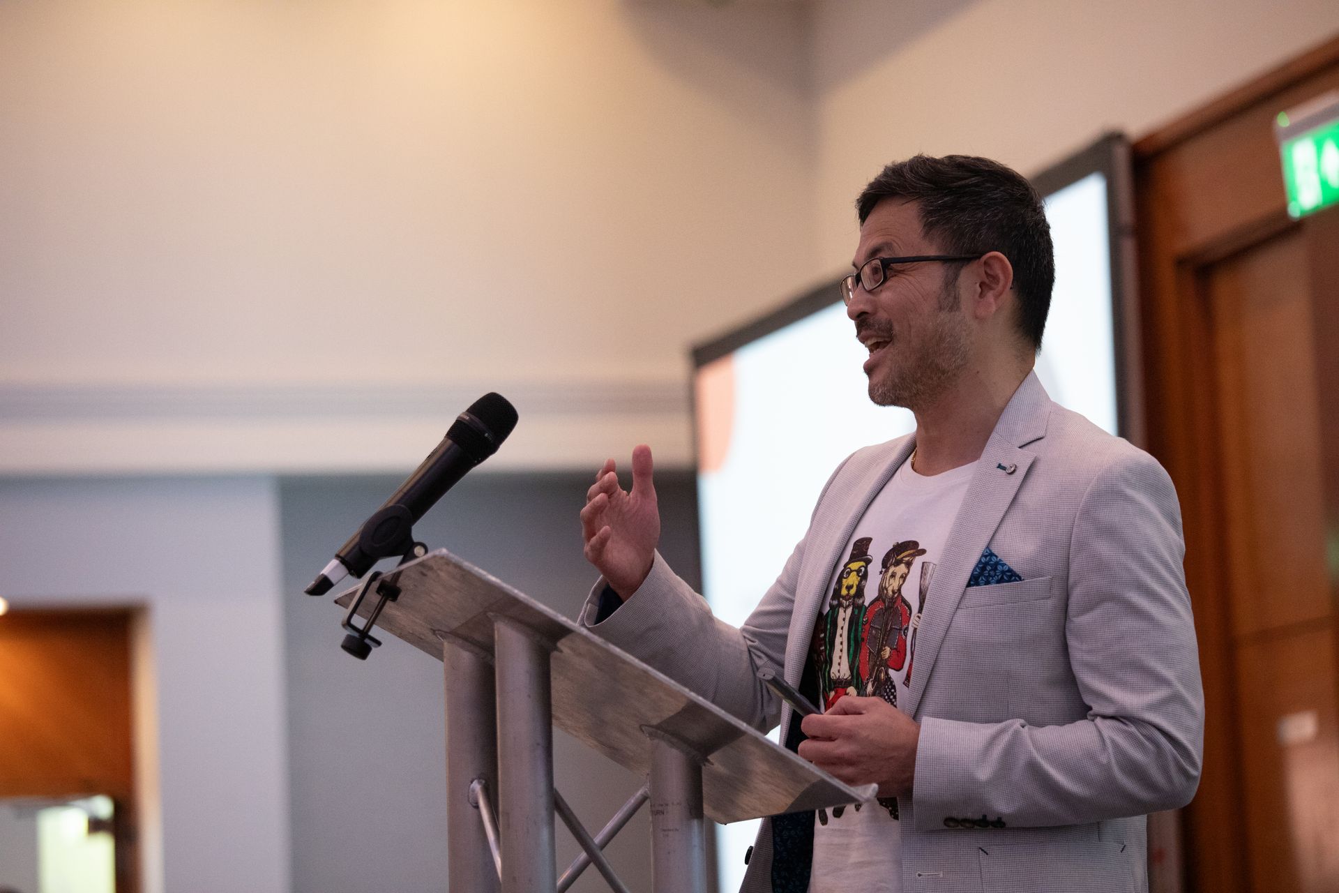 A man is giving a speech at a podium with a microphone.