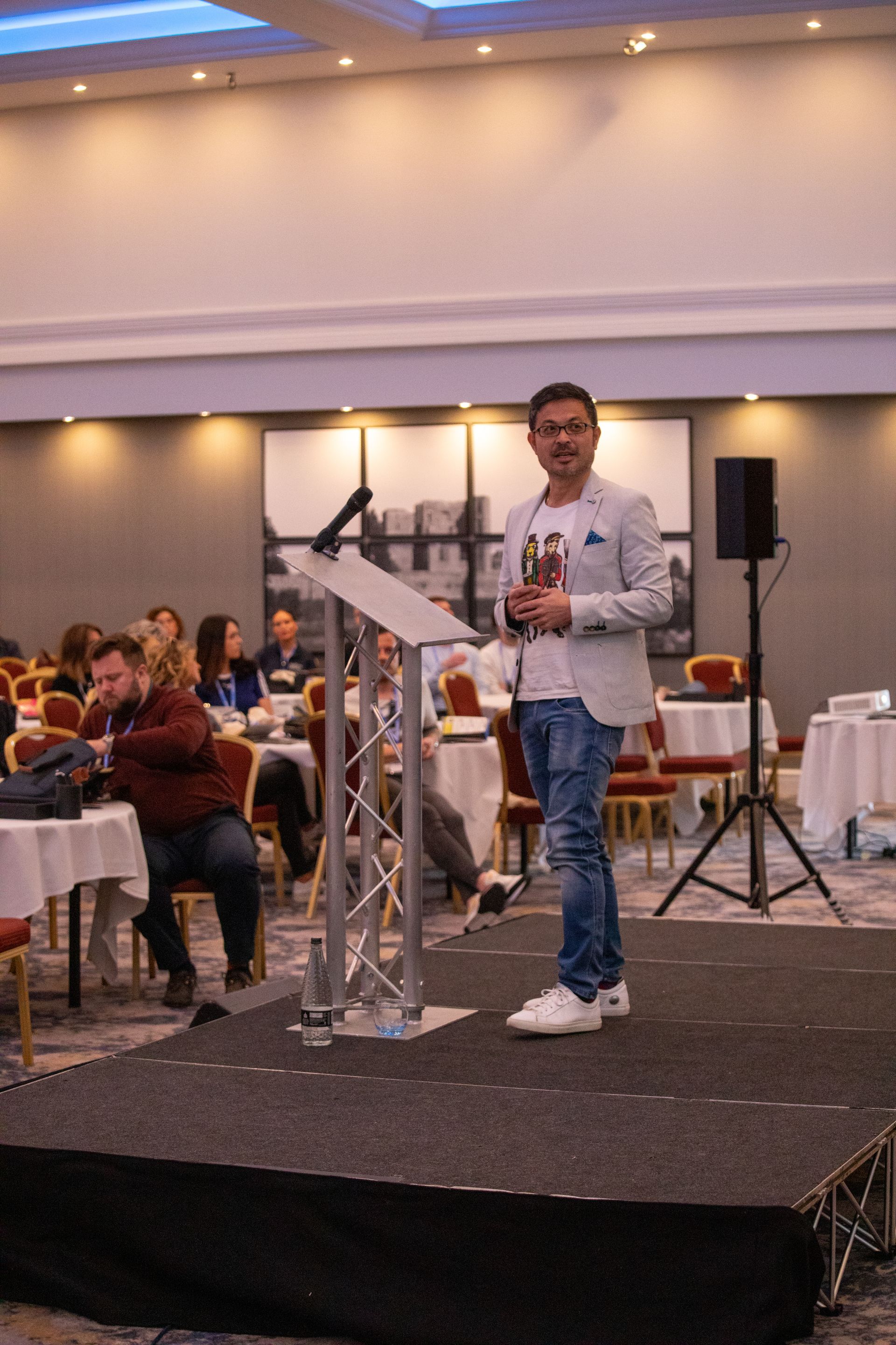 A man is standing on a stage giving a speech.