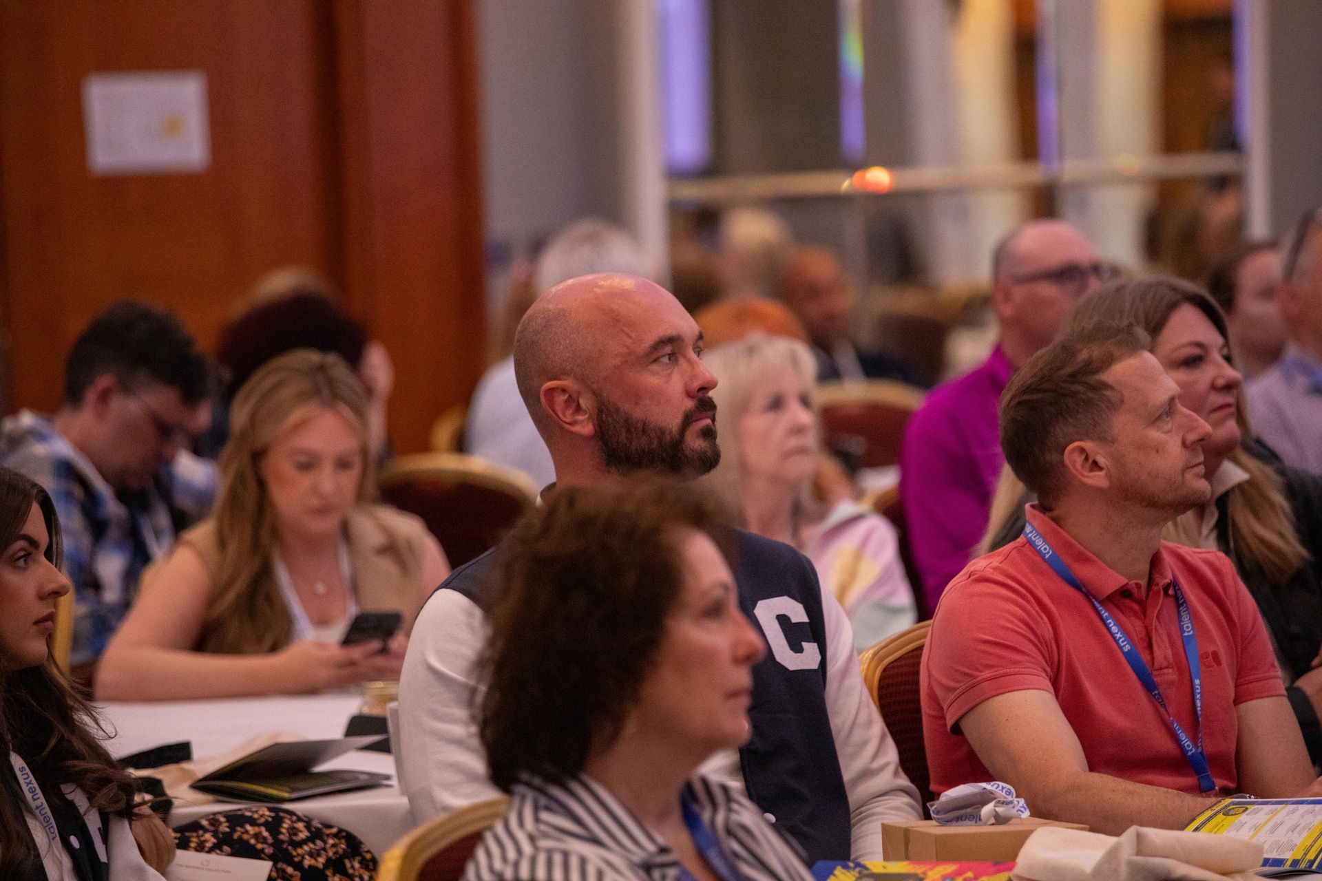 A group of people are sitting at tables in a room.