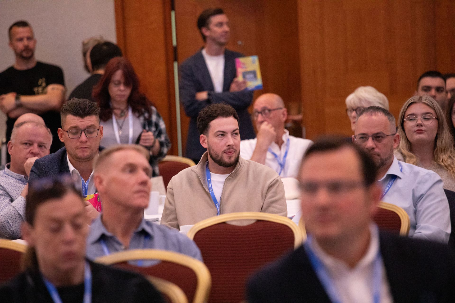 A group of people are sitting in chairs at a conference.