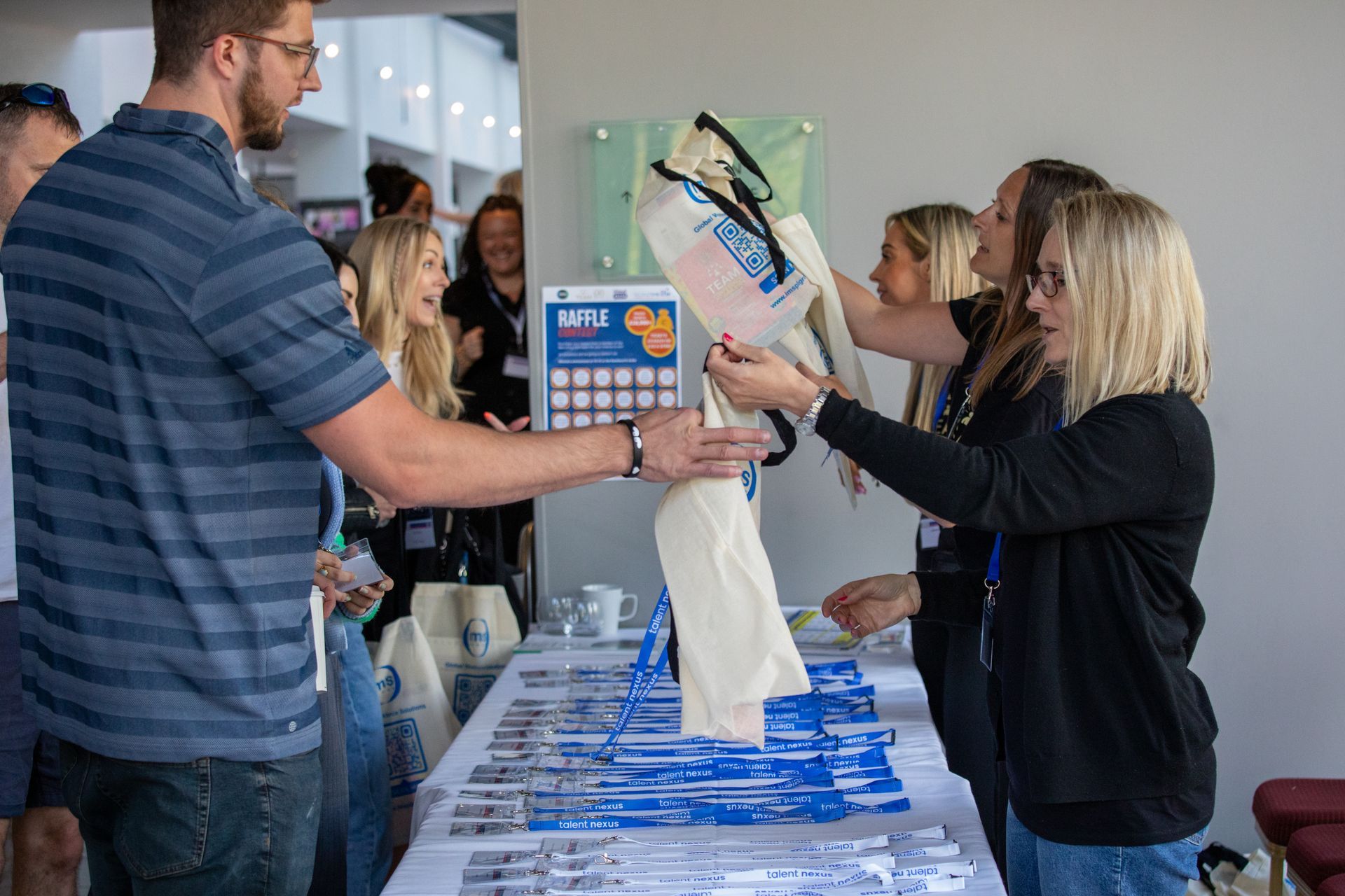 A group of people are standing around a table.