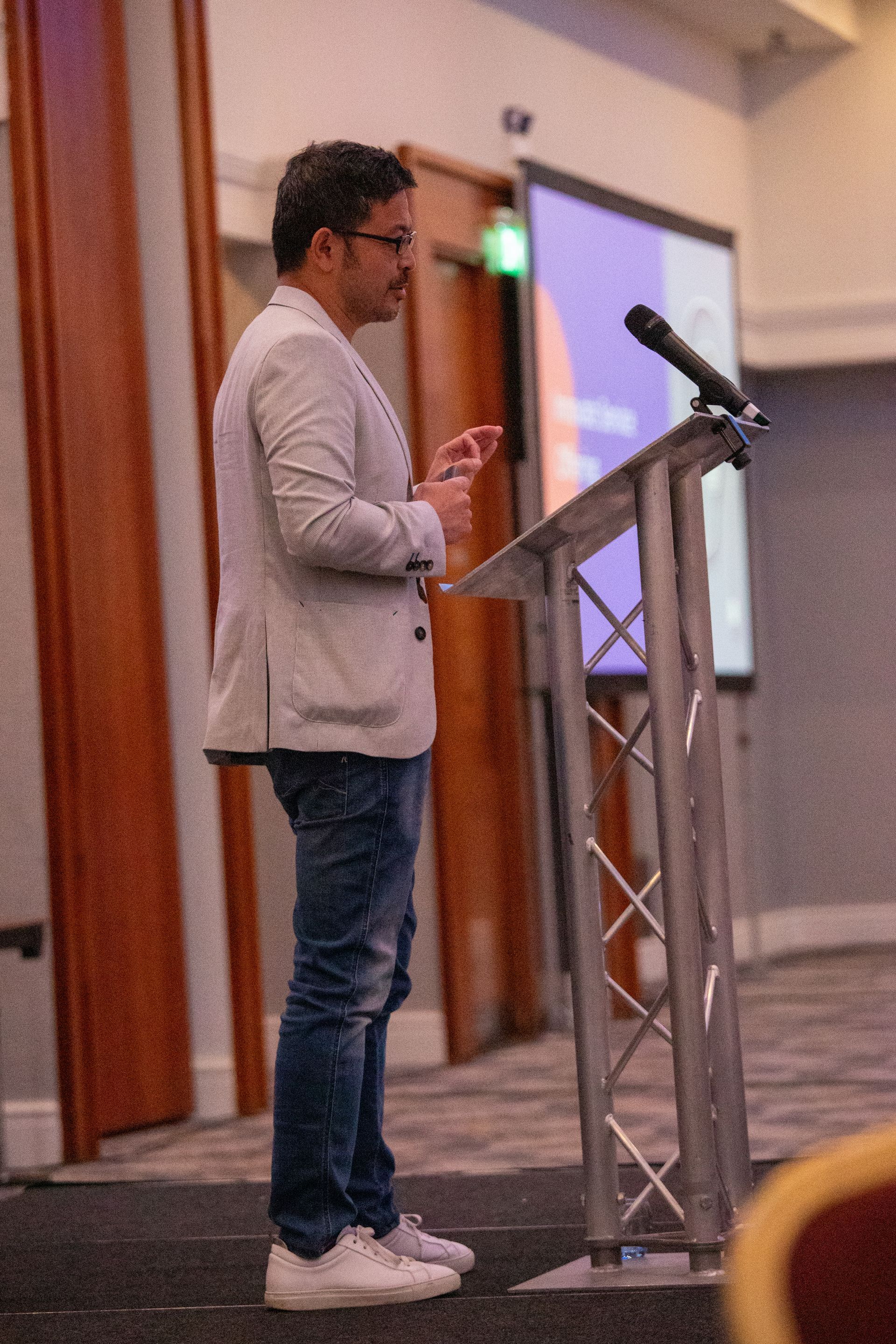 A man is standing at a podium giving a speech.